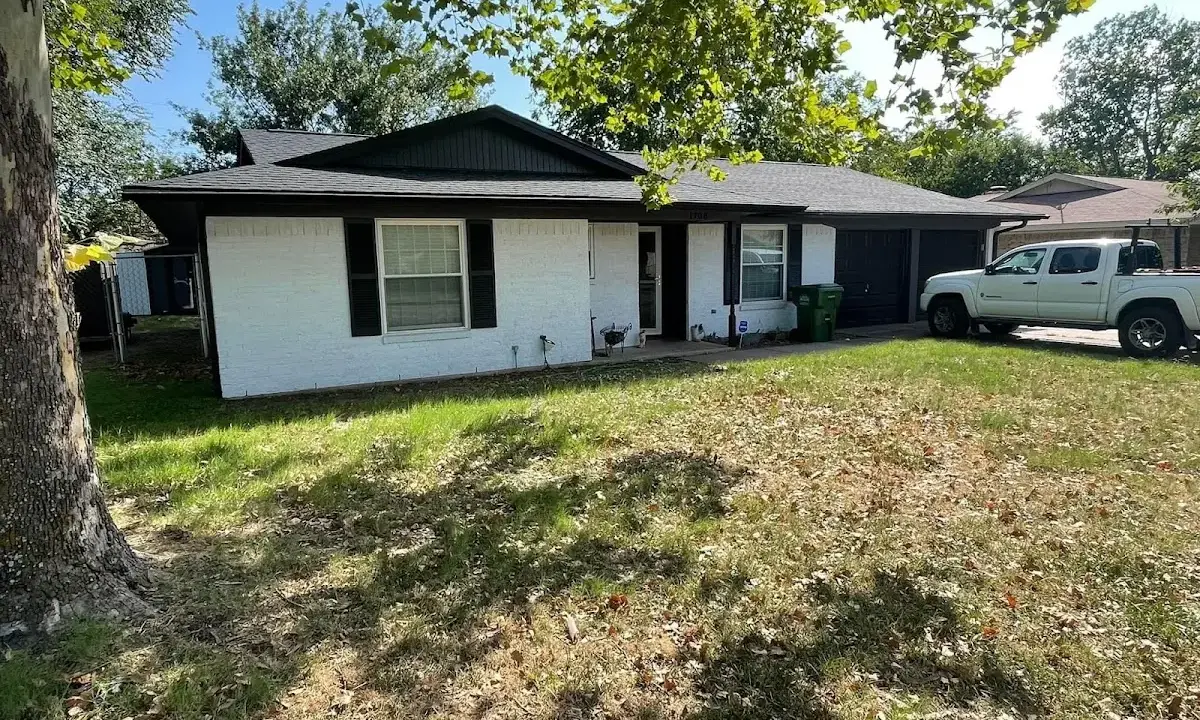 Professional roofing crew working on a residential roof in West Jefferson